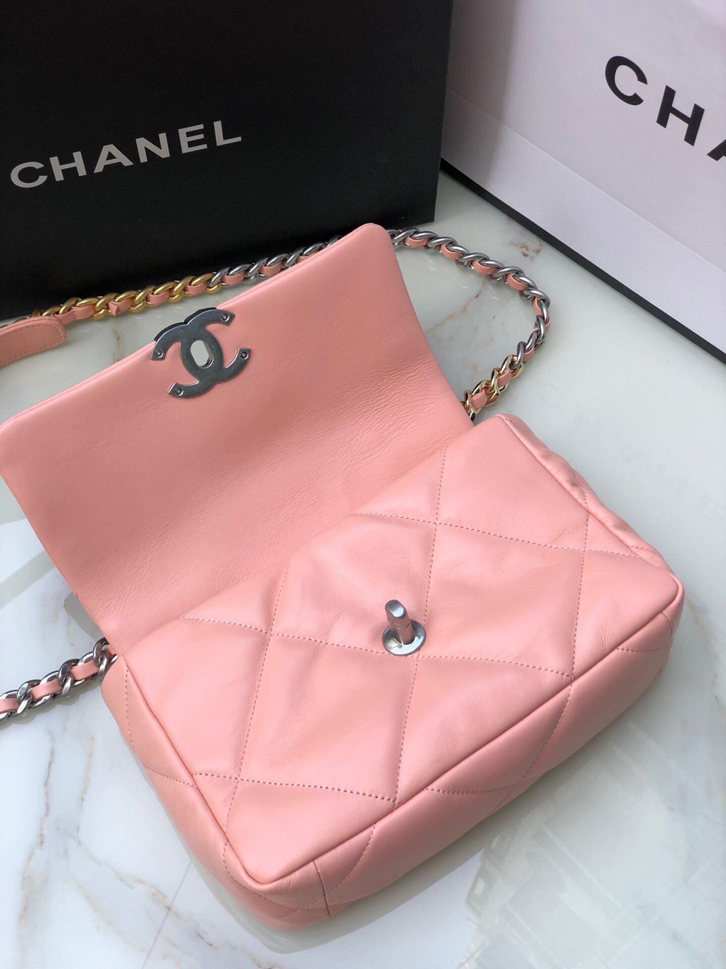 Ch*el 19 handbag shiny leather, gold-tone, silver-tone & ruthenium-finish metal light pink 6.2 × 10.1 × 3.5 in