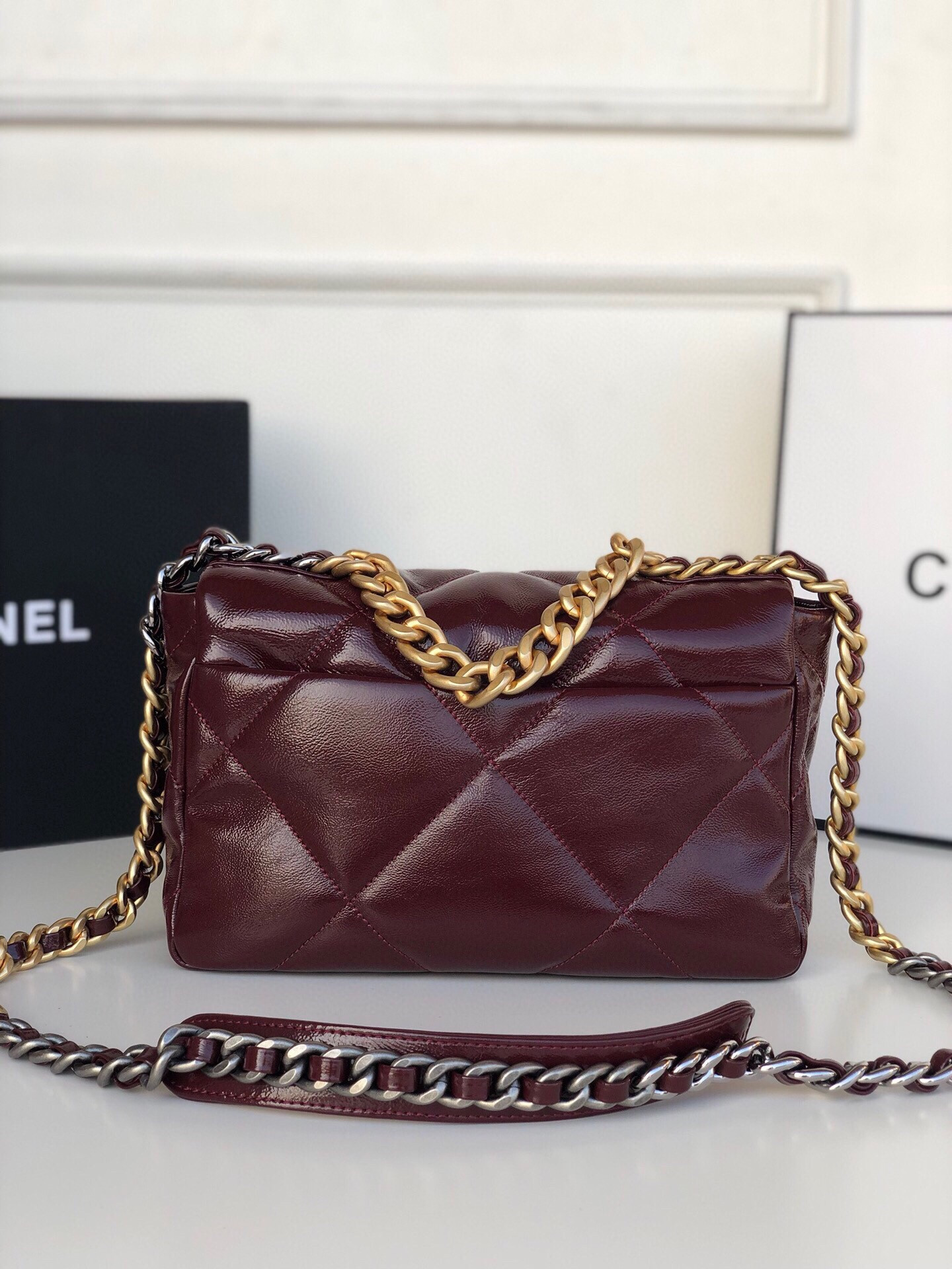 Ch*el 19 handbag shiny leather, gold-tone, silver-tone & ruthenium-finish metal dark red 6.2 × 10.1 × 3.5 in