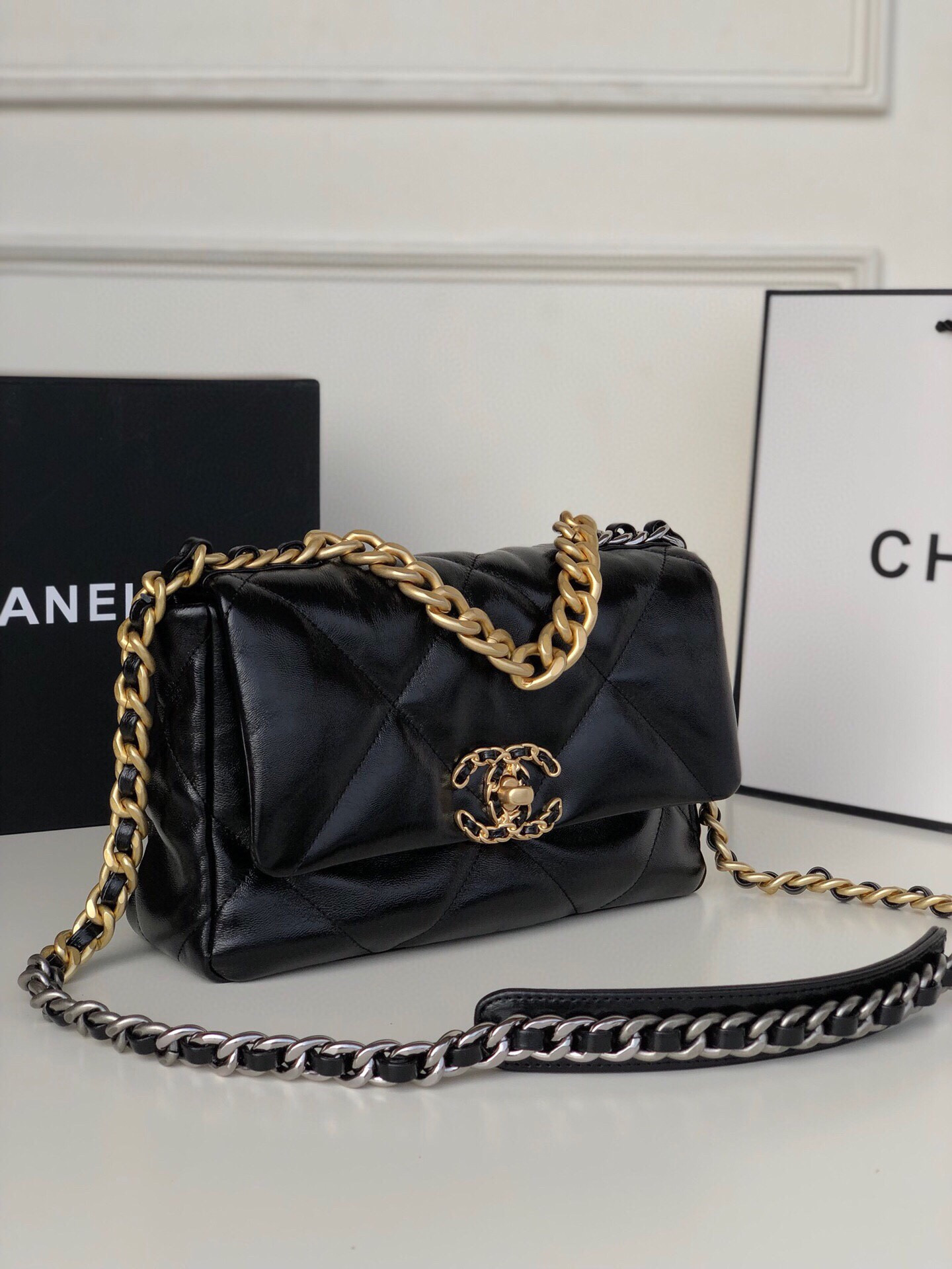 Ch*el 19 handbag shiny leather, gold-tone, silver-tone & ruthenium-finish metal black 6.2 × 10.1 × 3.5 in