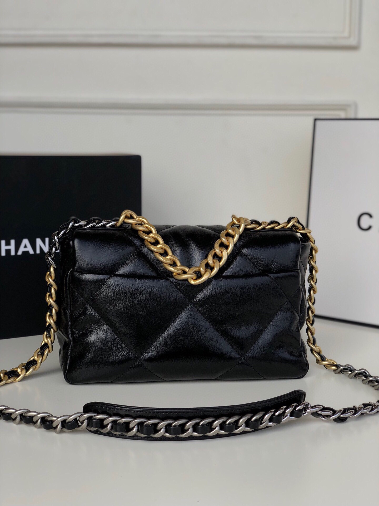 Ch*el 19 handbag shiny leather, gold-tone, silver-tone & ruthenium-finish metal black 6.2 × 10.1 × 3.5 in