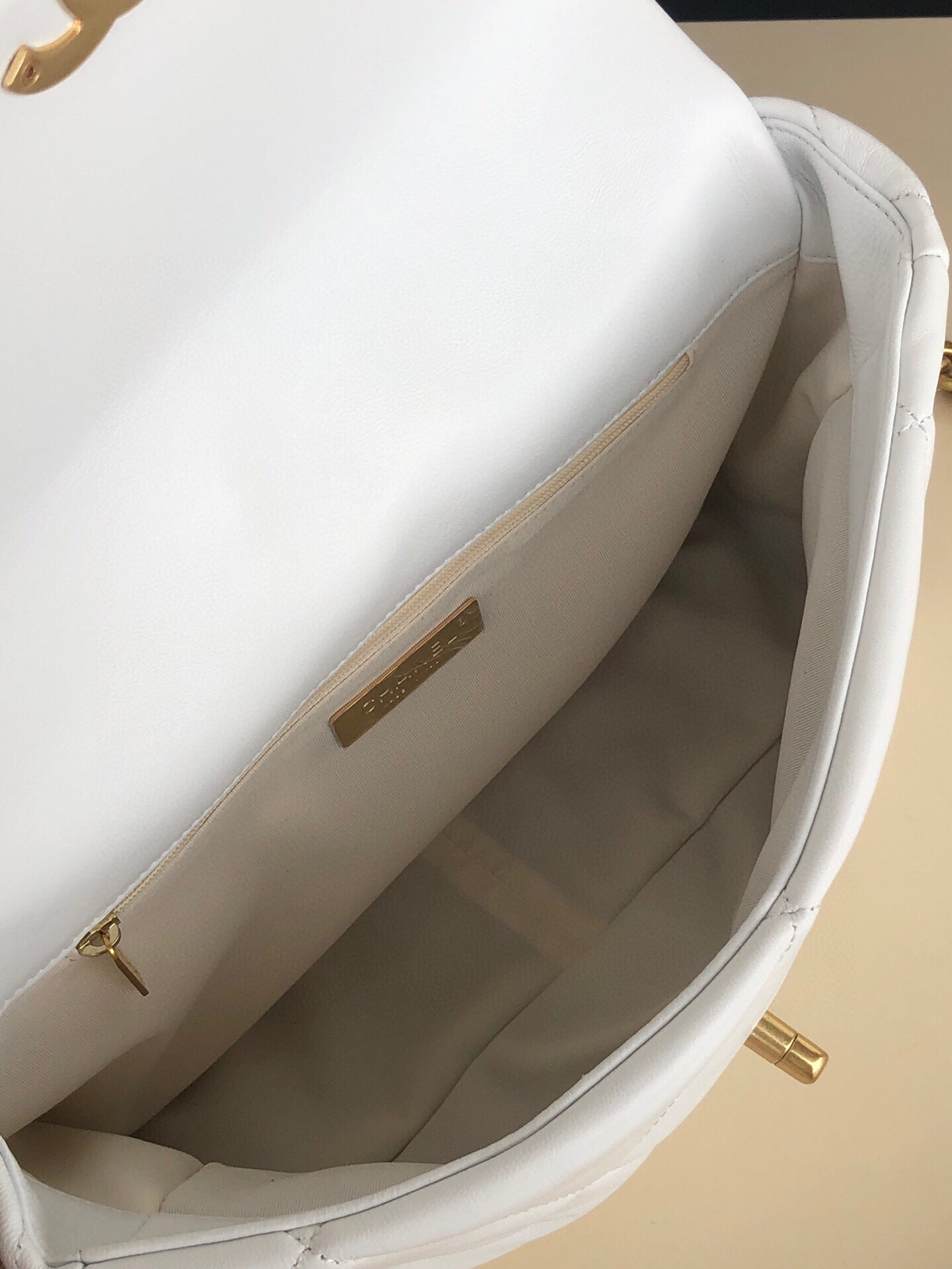Ch*el 19 large handbag shiny leather, gold-tone, silver-tone & ruthenium-finish metal white 7.8 × 11.7 × 3.9 in